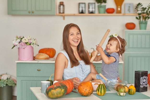 Mother and daughter in the kitchen with Thanksgiving decorations