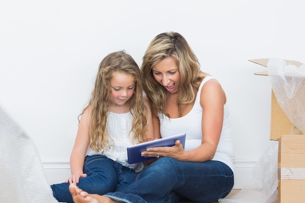 Mother and daughter looking using tablet pc