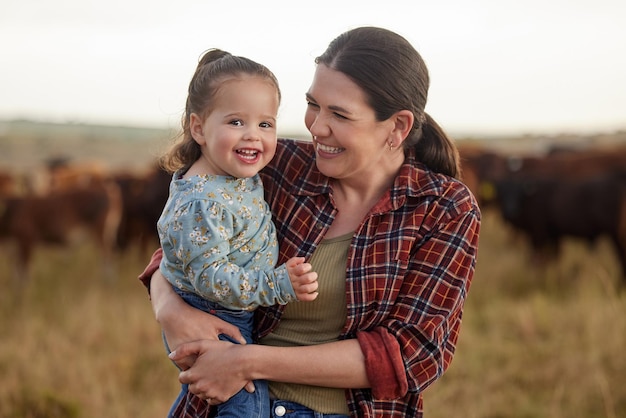 Mother and daughter love and family on a farm as a cattle farmer and child in the farming or agricultural industry Agriculture sustainability and relationship with a woman and her girl outside