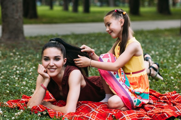 mother and daughter loving relationship. family at picnic at nature park