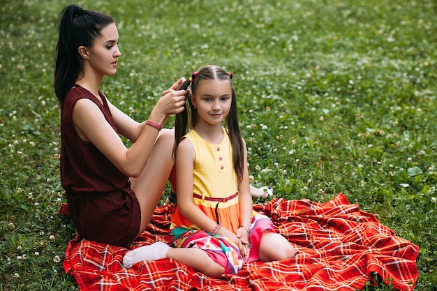 mother and daughter loving relationship. family at picnic at nature park