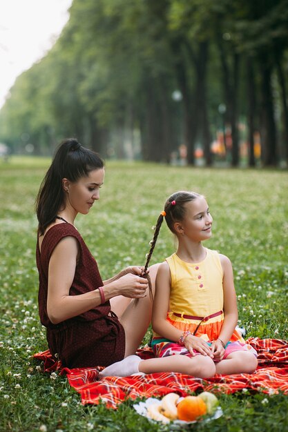 mother and daughter loving relationship. family at picnic at nature park