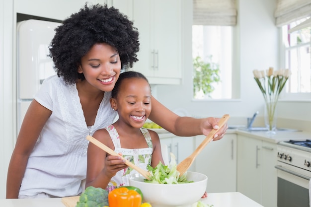 Mother and daughter making a salad together