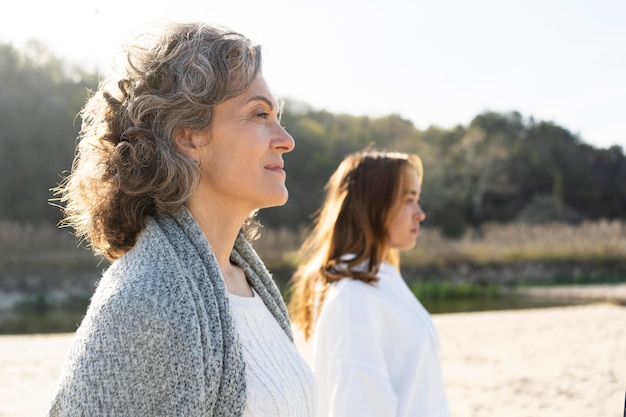 Mother and daughter outdoors on the beach together