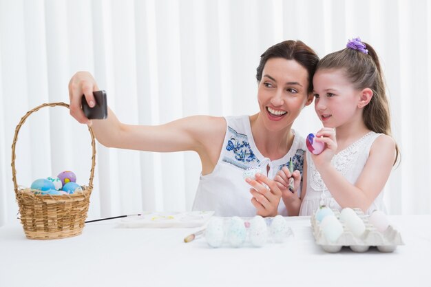 Mother and daughter painting easter eggs