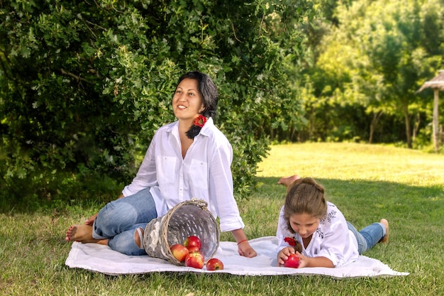 Mother and daughter in the park on the grass