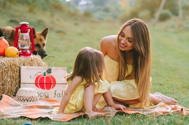 Mother and daughter at a picnic with a dog