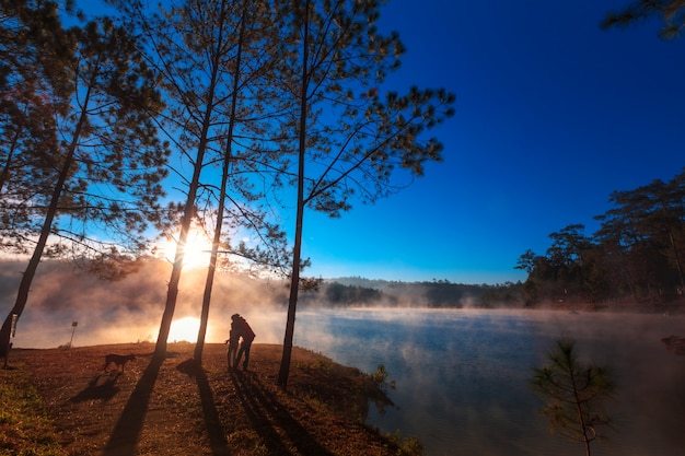 Mother and daughter under the pine forest on morning time 