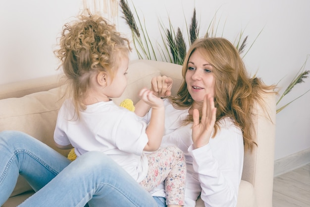 Mother and daughter play at home. Cheerful family.