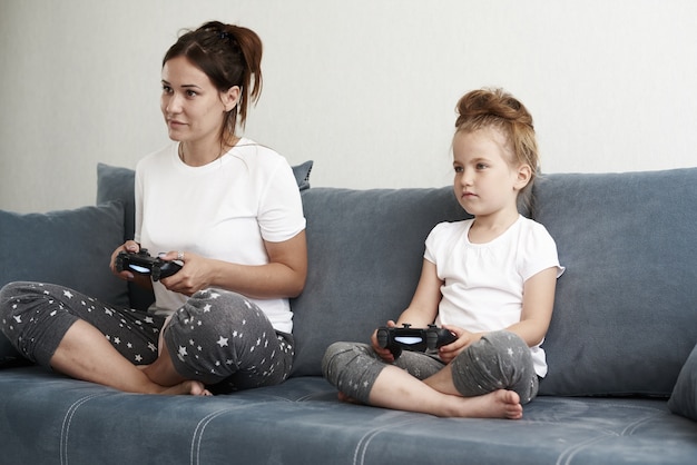 Mother and daughter playing computer games