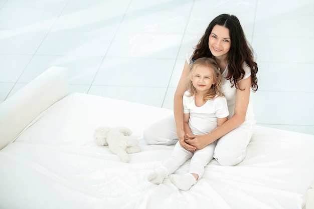 Mother and daughter playing on the sofa in the living room