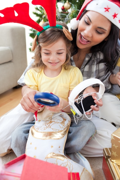 Mother and daughter playing with Christmas presents