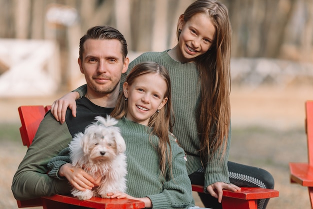 Mother and daughter playing with dog outdoors