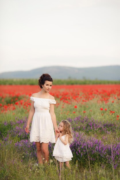 mother and daughter in poppy field