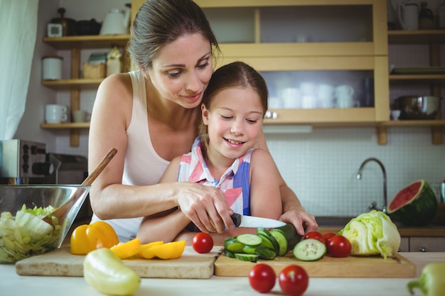 Mother and daughter preparing salad