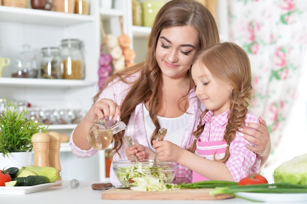 Mother and daughter preparing salad