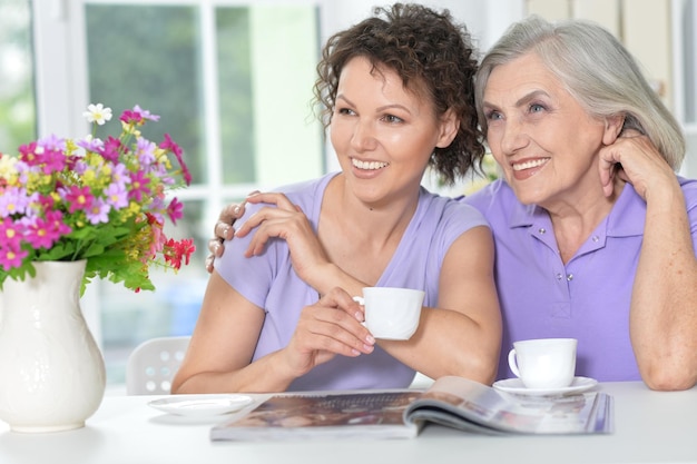 Mother and daughter reading magazine