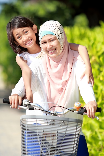 Mother and daughter riding bike