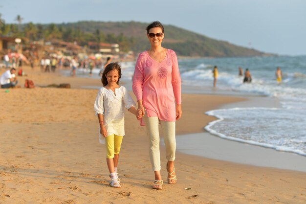 Mother and daughter on sandy beach