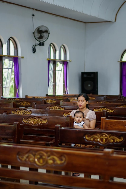 mother and daughter sitting in church