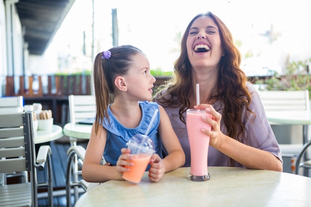 Mother and daughter sitting outside the cafe