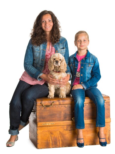 Mother and daughter sitting in a wooden chest