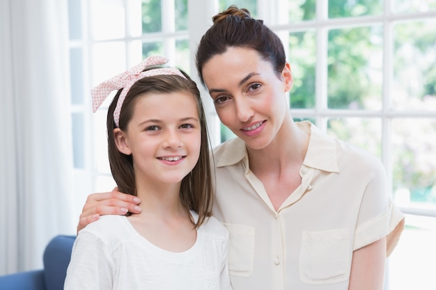 Mother and daughter smiling at camera