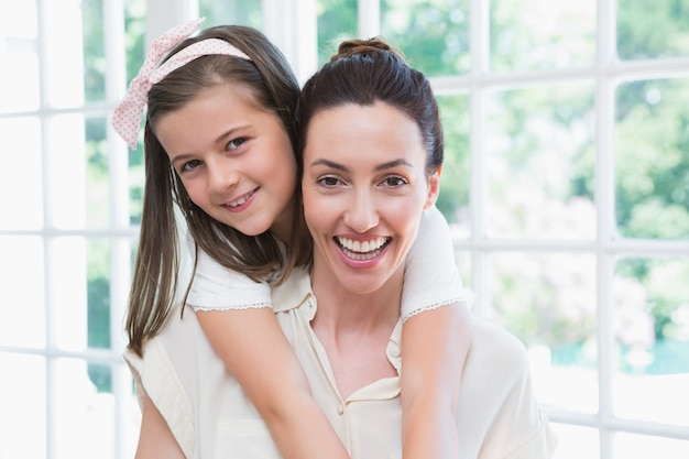 Mother and daughter smiling at camera