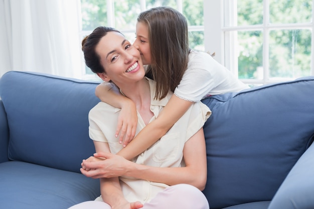 Mother and daughter smiling at camera