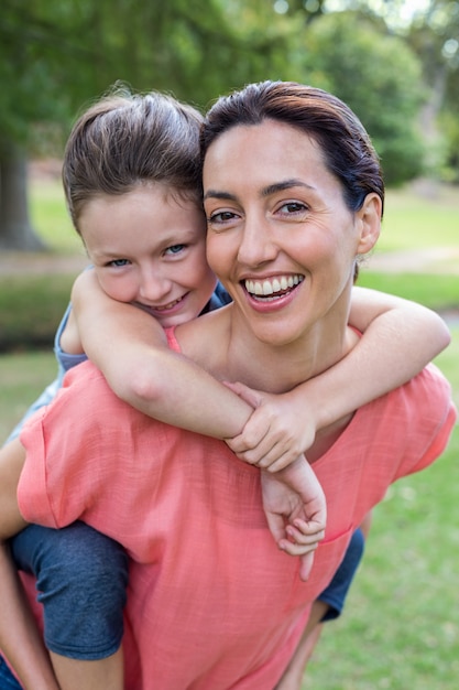 mother and daughter smiling at the camera