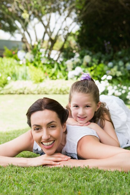 Mother and daughter smiling at camera