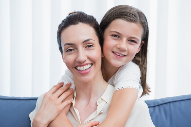 Mother and daughter smiling at camera