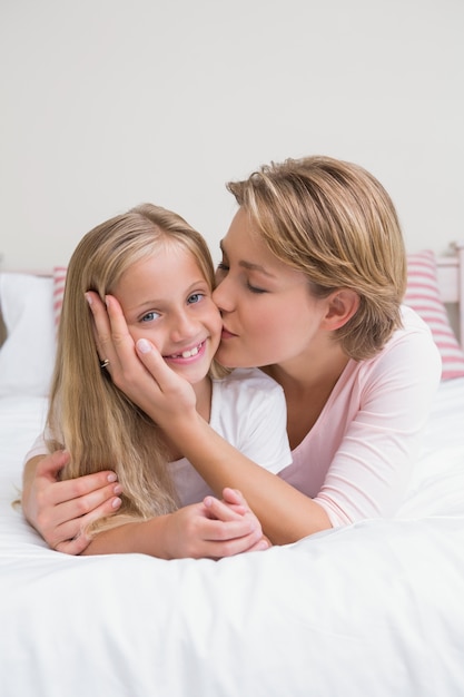 Mother and daughter smiling at camera