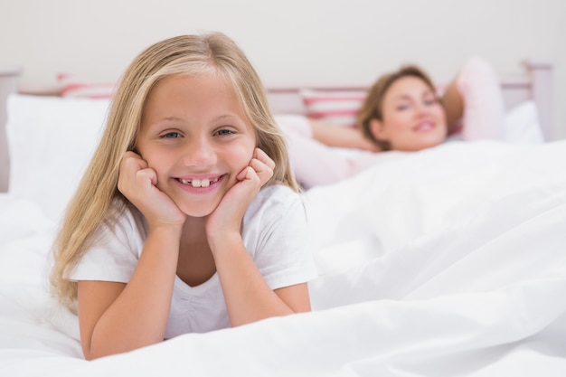 Mother and daughter smiling at camera