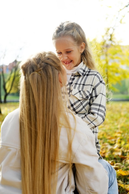 Mother and daughter spend time together in the autumn park