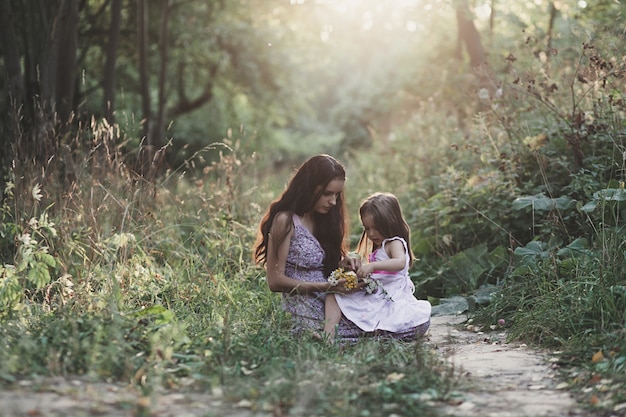 Mother and daughter in summer dresses