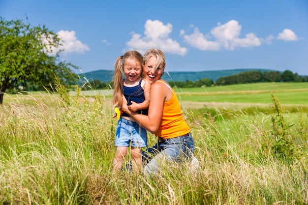 Mother and Daughter in summer on meadow