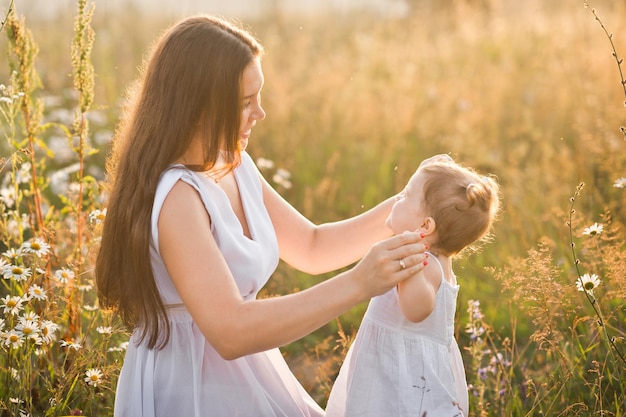 Mother and daughter in sunny photos play among dandelions 3021