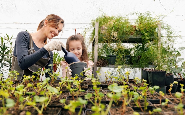 Mother and daughter taking care of plants