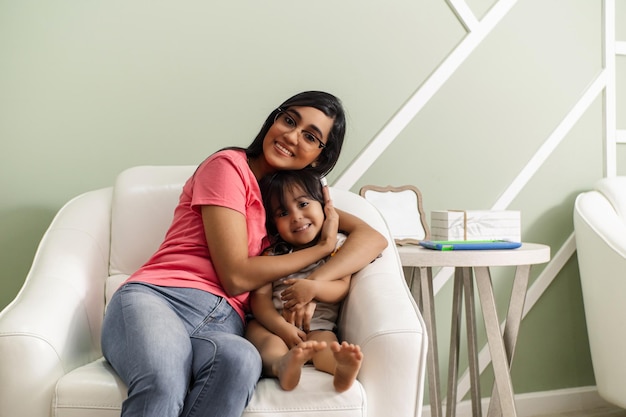 Mother and daughter together indoors