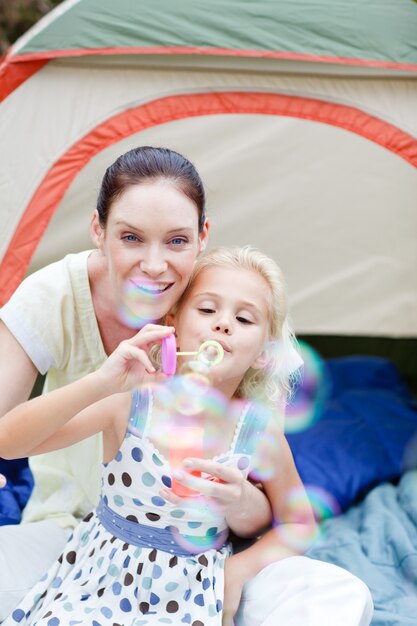 Mother and daughter together in tent