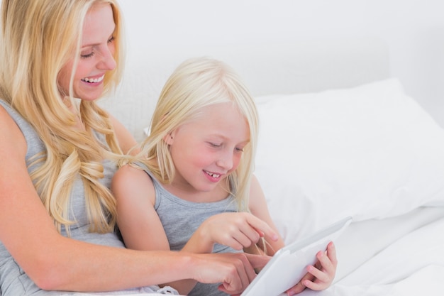 Mother and daughter touching a tablet