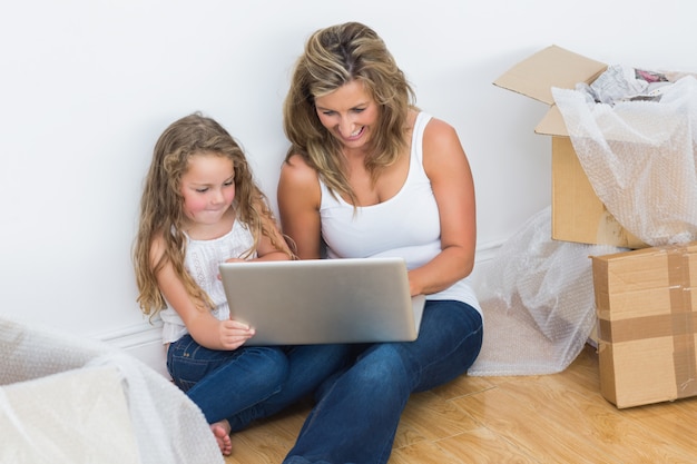 Mother and daughter using laptop