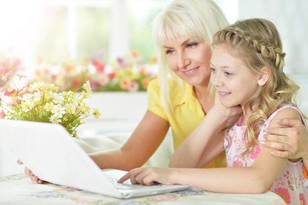 Mother and daughter using laptop