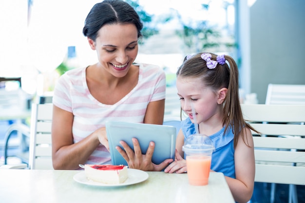 Mother and daughter using tablet computer together