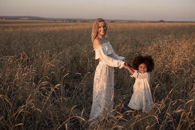 mother and daughter walking in an autumn field