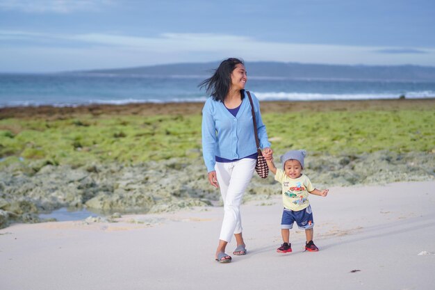 mother and daughter walking on the beach