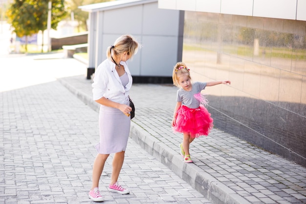 Mother and daughter walking down the street