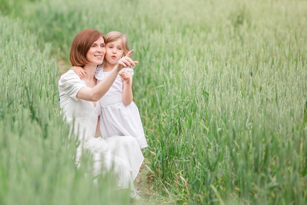 Mother and daughter walking in the field