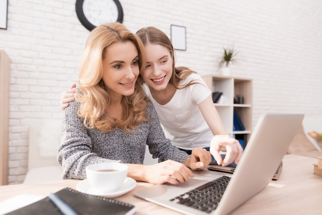 Mother and Daughter Watching into Laptop at Home.